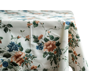 Elegant floral tablecloth draping over a table in soft light, enhancing a cozy dining setup with natural charm and inviting warmth isolated on transparent background