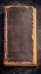 An antique leather-bound book rests on a smooth black surface, its weathered spine and faded gold lettering hinting at countless stories within. The contrast highlights its timeless charm.