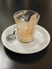 Finished glass of coffee with milk.