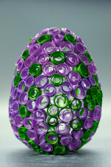 Decorative Easter Craft. Close-up of a handmade Easter egg adorned with rolled paper designs.