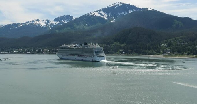 Big cruise ship sailing out from Juneau, Alaska. Water plane taking of close to the cruise ship. Douglas island with Mount Bradley in the background.