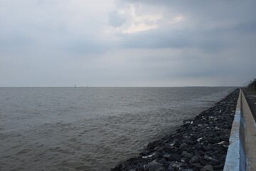 landscape of sea on sunset with rain cloud coming