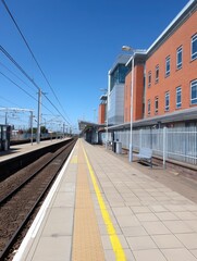 Fototapeta premium A single track stretching into the distance within the station - distance vanishing destination Train