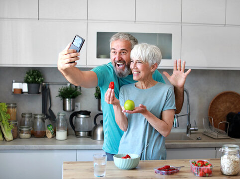 kitchen food woman healthy couple morning mature breakfast selfie portrait fun photo smartphone photography mobile camera mobile phone taking picture active fitness diet