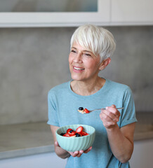 kitchen food woman healthy morning mature breakfast active fitness diet home healthy eating senior...