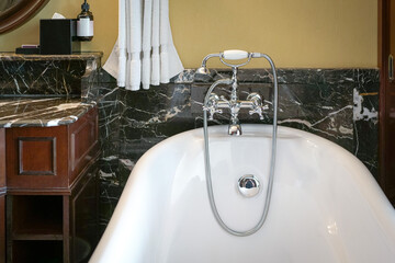Bathtub and faucet. Inside an elegant hotel.
