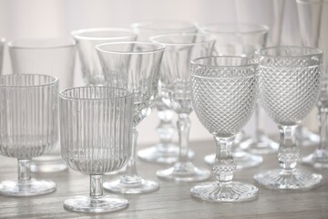 Empty clean glasses on wooden table indoors, closeup
