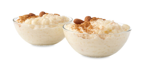 Delicious rice pudding with cinnamon and almonds in glass bowls isolated on white