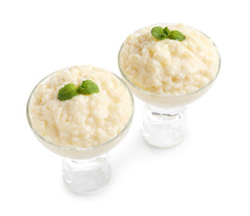 Delicious rice pudding with mint in glass dessert bowls isolated on white