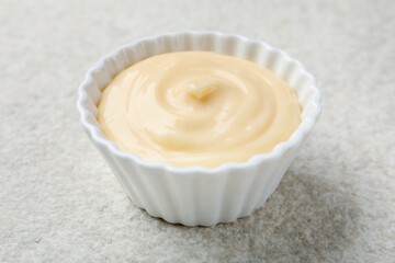 Tasty vanilla pudding on light textured table, closeup
