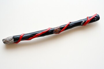 A cursed black twig covered in eerie glowing red veins, resting on an ancient stone altar