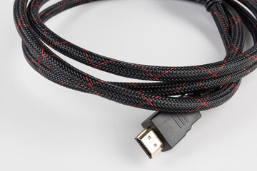 HDMI cable on a white background. HDMI cable rolled into a roll.