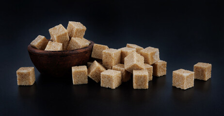 Clay cup with brown sugar cubes. Cane brown sugar.