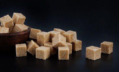 Clay cup with brown sugar cubes. Cane brown sugar.