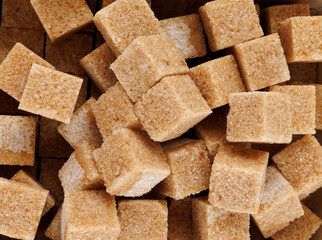 Background of brown sugar cubes. Cane brown sugar.