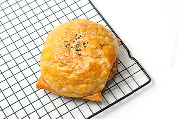 bread with soy sauce chicken filling on a wire rack