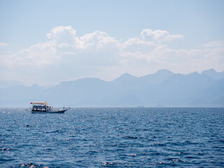 Sea and mountains in Antalya, Turkey. A magical fairy-tale landscape. A ship is sailing against the background of the mountains.