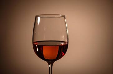 glass of pink wine on a colored background.