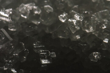 White sugar crystals in macro – detailed close-up of crystalline structure used in food,...