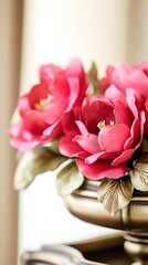 Vibrant Pink Artificial Flowers in Gold Vase Closeup