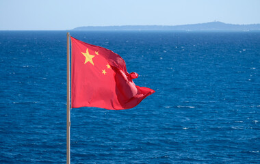 Chinese national flag at the coast near the sea