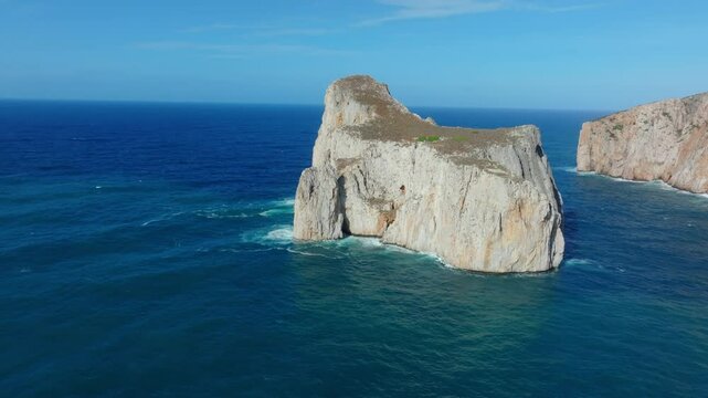 Establishing Aerial shot of Pan di Zucchero near Masua, Sardinia, rising from the Mediterranean with steep white cliffs, calm waves, and expansive sky, showcasing Italy&rsquo;s island rugged coastline