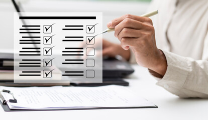 Business performance checklist  and businessman review document and check mark at workplace 