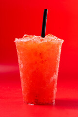 Red strawberry slushie isolated on red background. 