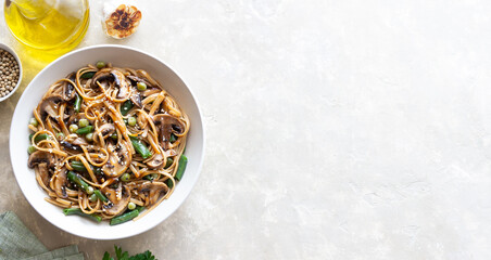 Fototapeta premium Udon noodles in teriyaki sauce with mushrooms, beans and peas. Asian cuisine. Vegetarian food.