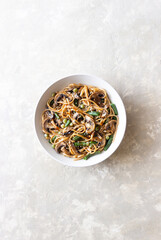 Udon noodles in teriyaki sauce with mushrooms, beans and peas. Asian cuisine. Vegetarian food.