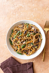 Udon noodles in teriyaki sauce with mushrooms, beans and peas. Asian cuisine. Vegetarian food.