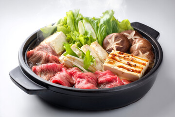 Delicious hot pot with beef tofu mushrooms vegetables fresh ingredients steaming hot healthy meal Asian cuisine