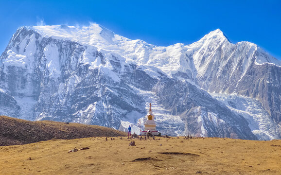 Himalayas, Nepal - The famous hiking on the roof of the world called Annapurna Circuit in the Himalaya range mountain, with little village, buddhist stupa and mountains of 8000 meters.