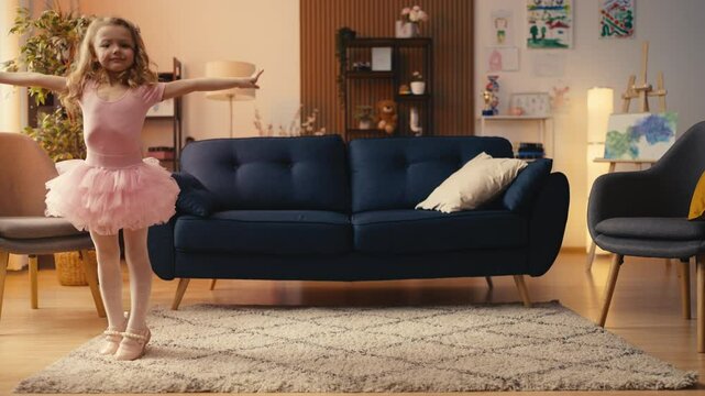 Lovely little girl in tutu dress doing cartwheel at home, practicing acrobatics