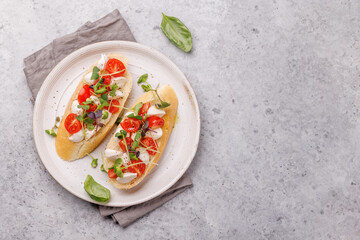 Tasty antipasto toasts featuring classic caprese with mozzarella and tomatoes, and savory prosciutto with herbs