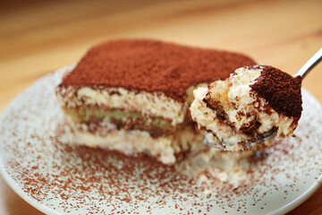 Closeup of a Spoon Scooping Mouthwatering Tiramisu Cake