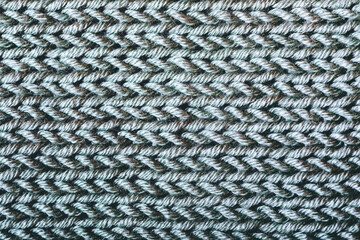 A close up of a knitted fabric with a grayish color