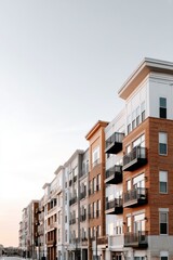 Fototapeta premium Apartment complex with diverse architectural features, balconies, and terraces - aesthetic materials diverse outdoor rooftop