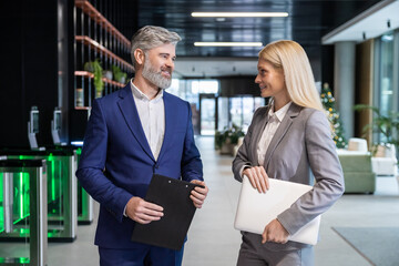 Entrepreneur and businessman standing in workplace discussing partnership