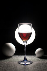 Still life with wine glass and foam balls	