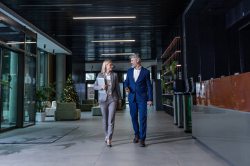 Business partners walking in office communicating about corporate decisions