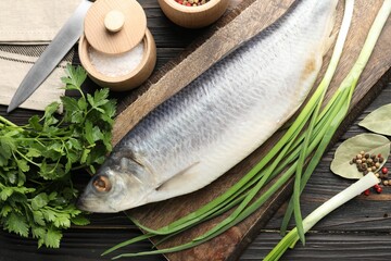 Tasty herring with spices on wooden table, flat lay