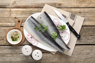 Tasty herring fillets with spices on wooden table, flat lay