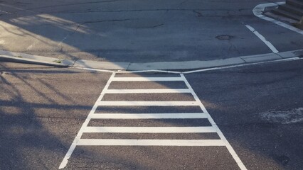 Fototapeta premium A street with a white line painted on the ground and a crosswalk