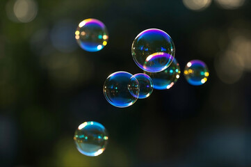 Dreamlike soap bubbles floating in soft light with vivid reflections. Surreal and photorealistic atmosphere