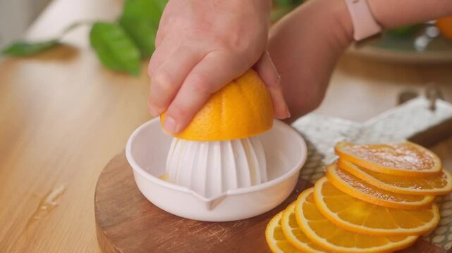 Closeup of hand juicing a lemon on manual citrus reamer