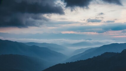 Obraz premium Majestic mountains in mist during sunset.