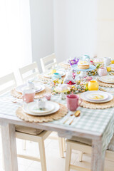 Easter table with pink, blue and yellow settings
