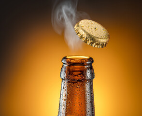 Opening beer bottle on brown background. Gas cloud going out of the beer bottle blowing away the...