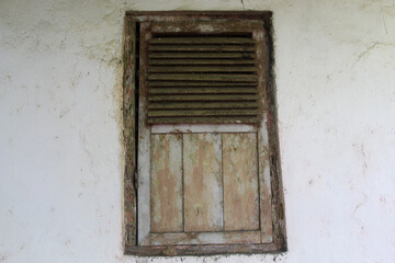 Old wooden windows that are worn and rotten
